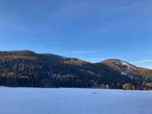 Waterhouse and Powderhouse Peaks as the morning sun first hits with no visible snow on trees.