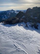 The summit of Waterhouse with previous boot prints visible and areas on zero new snow.