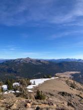 The clear line of snow to the south of the summit.