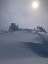 Earlier in the day blowing snow and cloud cover obscured the views above treeline, but the wind reduced and visibility improved later.