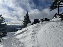 Heavily wind affected snow in exposed areas, gullies and drainages within tree line.