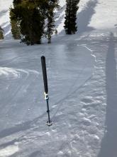 Shiny ice layer extending roughly 50 feet down this slope.