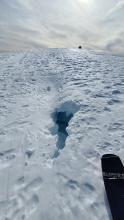 A depression and hole revealing a sizeable moat on a cornice near Mt Judah on Donner Summit.