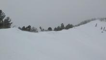 NE winds scouring a NE facing slope and blowing snow over the ridge.