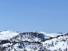 Plumes of blowing snow along the high peaks in Desolation Wilderness.