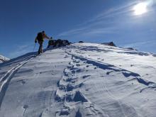 Scouring along the NE side of the ridgetop by NE winds.