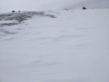 Wind sculpted snow and scoured areas on the windward side of the ridge.