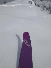 Recent new snow wind scoured away, leaving exposed rain crust on an E aspect near treeline.