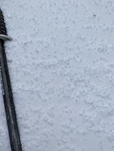 Graupel on the surface, pooling in depressions and on leeward slopes